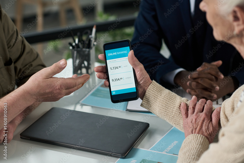 Poster senior woman learning to use banking app on her smartphone while having consultation with financial 