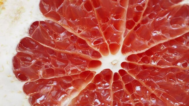 Juicy grapefruit segments reveal vibrant red interior