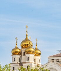 The golden domes of the Christian church in sunset light.