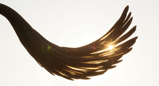 Abstract Dark Object with Sunburst Against Bright Sky