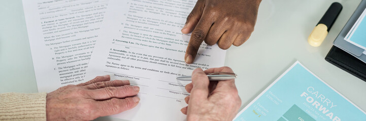 Header with senior woman signing contract at meeting