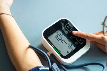 Man check blood pressure monitor and heart rate monitor with digital pressure gauge. Health care...