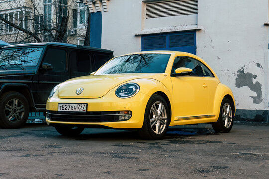 vw beetle yellow car parked in the street