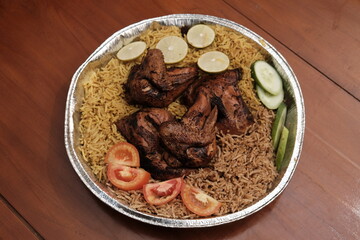 A big plate of kabuli and biryani rice, grilled chicken side dish, with tomato garnish, sliced cucumber and lemon, arabian food,  best of Arabian dishes.