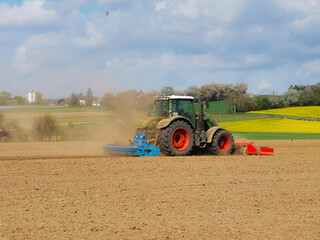 Extreme dryness in Spring. Farmer preparing soil with tractor and cultivator for sowing
