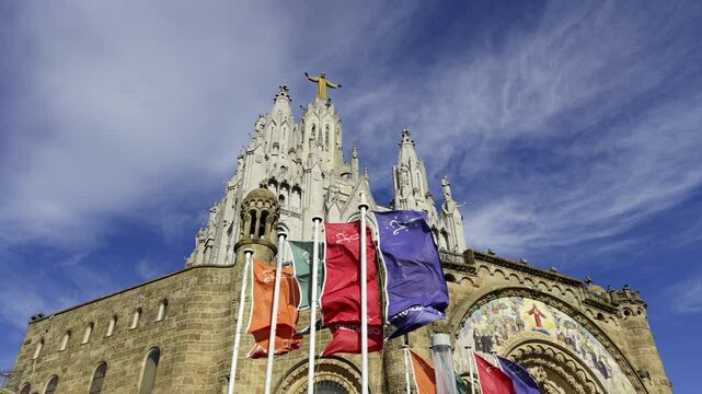 Temple expiatori del sagrat cor waving flags on sunny day. Action