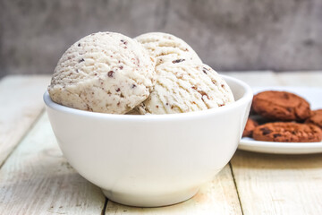 a bowl of vanilla scoop ice cream, on the table