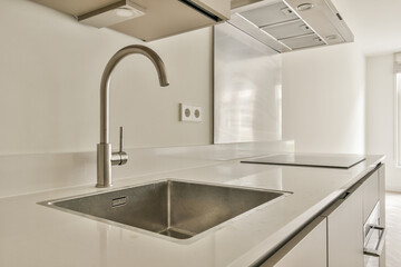 A sleek and contemporary kitchen showcasing stainless steel appliances, a minimalist design, and a spacious countertop for cooking and entertaining.