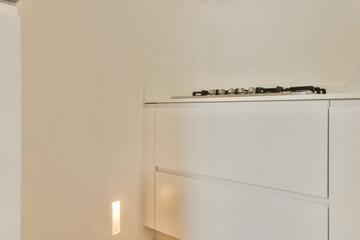 A sleek and modern kitchen featuring clean lines, minimalistic cabinets, and soft lighting,...
