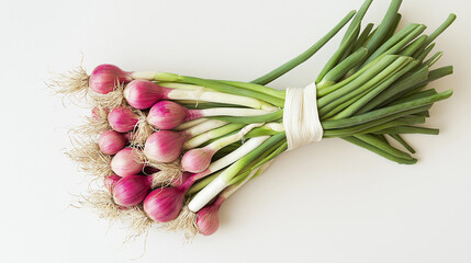 A creative interpretation of vibrant root and leaf vegetable medley: calçot, chives, shallots, leeks, welsh onions, and pearl onions on a natural background.