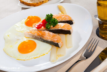 Fried salmon with scrambled eggs and asparagus. High quality photo