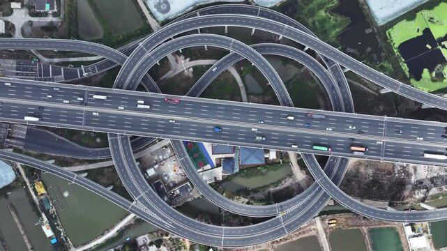Multi-level overpass China. Lot cars drive on transportation interchange. Road traffic. Chinese economy. Aerial top drone above view of fast urban highway. Modern city freeway. Busy auto express way.