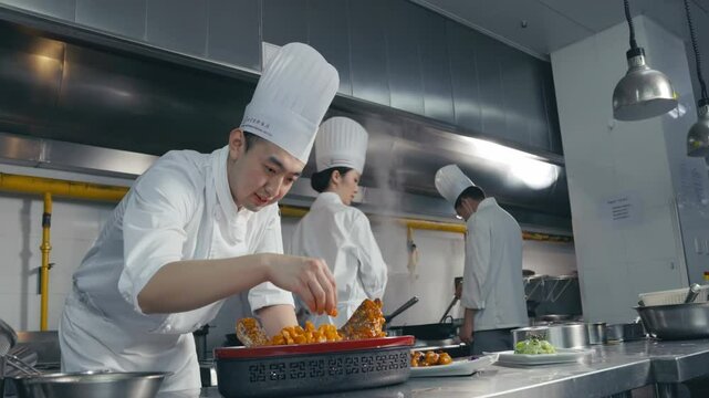Professional chefs Focused Decorating Food In The Kitchen In A Close-Up Shot Showing Attention To Detail And Culinary Skills.