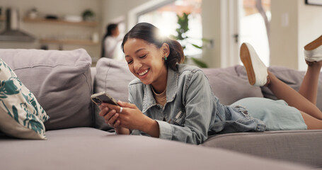 Home, funny and teenage girl on sofa, smartphone or typing with smile, online humor or text....