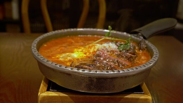 Freshly Cooked Steak Shakshuka Dish On Pot Served At Middle Eastern Restaurant. - closeup shot