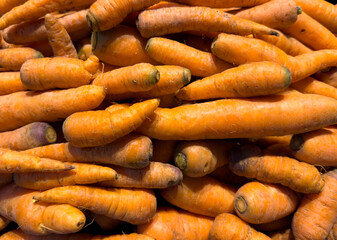 A pile of carrots with some of them being cut off