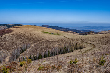 Serene landscape of rolling hills under a clear blue sky.