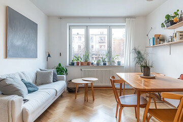 Scandinavian-style living room interior with a sofa, wooden table, and chairs near a window in a white apartment. 