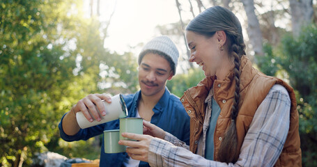 Outdoor, camping and couple with coffee, forest and bonding with warm beverage in nature and adventure. Hiking, travel and people with hot tea for cold weather, traveller and tourists on vacation