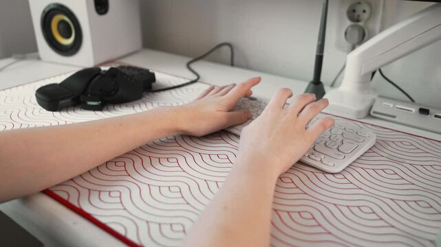 Close-up of female teen hands on white keyboard. Modern gaming and typing scene with clean aesthetics and tech lifestyle elements for digital generation visuals.