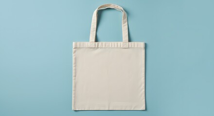 ai image presenting a blank beige canvas tote bag mockup, laid flat on a light blue background, ready for design placement.