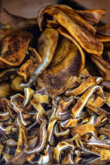 Smoked pig ears cut into small pieces are appetizingly laid out on  display case. Street trade. Favorite delicacy in Romania. Full frame. Close-up. Selective focus.