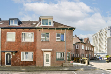 A view of modern and traditional residential buildings side by side in an urban area, showcasing diverse architectural styles.