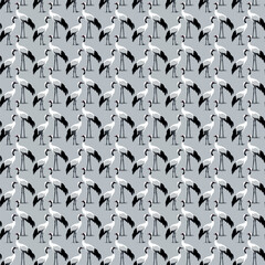 Fototapeta premium Stylizowane żurawie w powtarzalnym układzie geometrycznym na delikatnie niebieskim tle, idealne do tkanin, tapet lub projektów cyfrowych. 