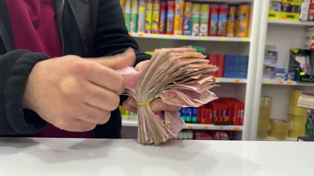 The hand of a man counting a stack of banknotes at work. Turkish Lira