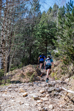 Couple hiking in the magnificent landscapes of the Cirque de Gavarnie in the Pyrenees, a UNESCO World Heritage Site.