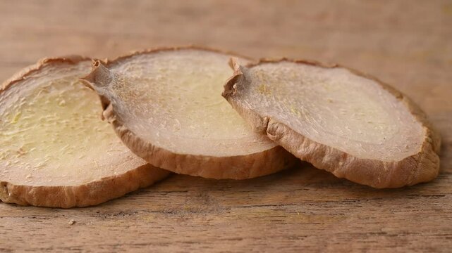 Dried galangal on a wooden floor