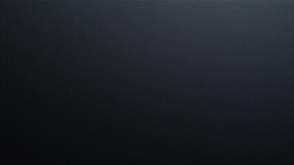 A smooth, non reflective surface of deep black, reminiscent of charcoal, finely textured with microscopic pits that catch the light.