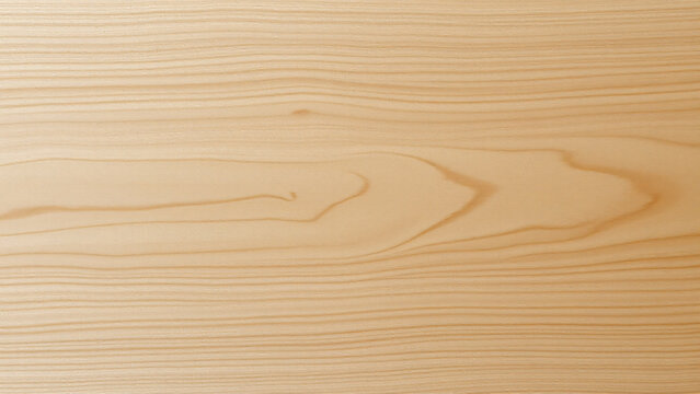 A tabletop crafted from blonde maple wood, seen from directly above, revealing a tight, uniform grain pattern and a soft, almost pearl like sheen