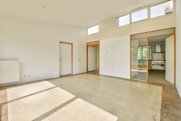 Spacious minimalist room with abundant natural light, featuring simple architecture and a subtle...