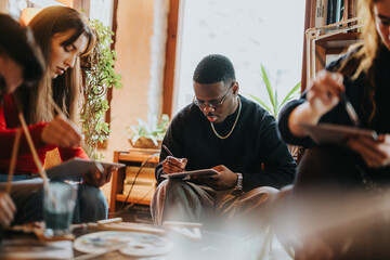 A creative group activity with friends painting and drawing, fostering togetherness and creativity. Social moment filled with artistic expression and collaboration in a comfortable, sunlit environment