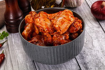 Raw marinated buffalo chicken wings