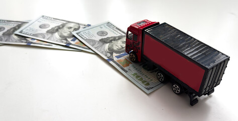  USD dollar bills, a trailer truck , depicts wasting time and paying a lot of money to buy things...