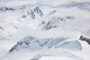 Snow-covered mountain peaks with clouds
