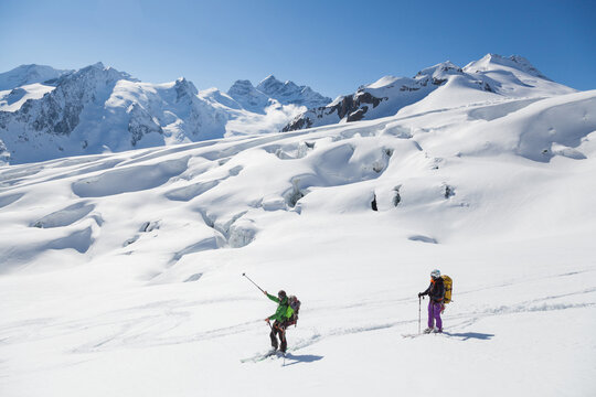 Backcountry skiers admire mountain views from Aletsch Glacier
