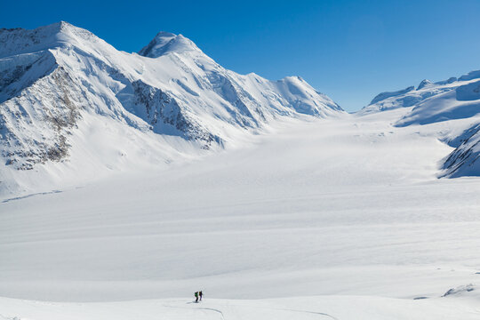 Backcountry skiers enjoy mountain view above Aletsch Glacier