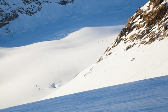 Backcountry skiers ascend glacier to climb Grosses Wannenhorn mountain