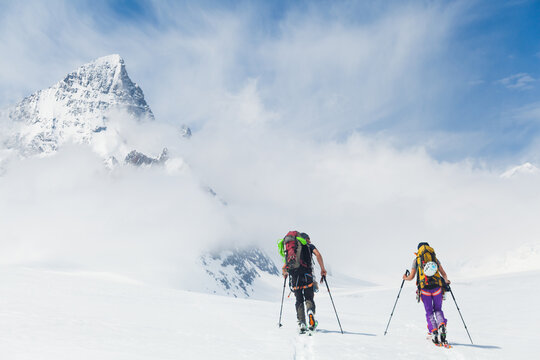 Two backcountry skiers chat as they cross Fiescher Glacier