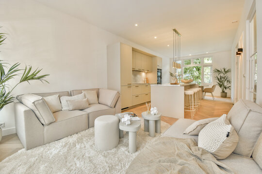 Bright and spacious living room featuring modern furniture, light tones, and an inviting atmosphere, perfect for relaxation and socializing.