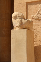 A head statue on the column at Temple of Hatshepsut in Valley of the Kings, Luxor, Egypt