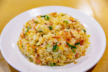 Close-up of sakura shrimp egg fried rice showing golden texture and tiny shrimp atop each grain, Taiwanese style on ceramic plate
