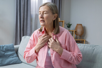 Woman suffering from heat and heartbeat and looking exhausted