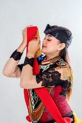 A Javanese traditional dancer performing Jathilan with grace and devotion, showing a serene and...