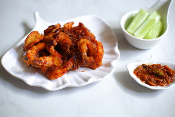 Grilled prawns with sambal and vegetable in white background 