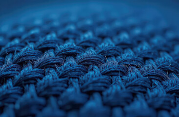 Closeup of blue textile weave pattern with detailed texture and interwoven threads