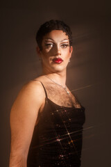 Confident Latin Drag Queen Poses in Studio With Mist and Star-Shaped Sparks for Striking Portrait